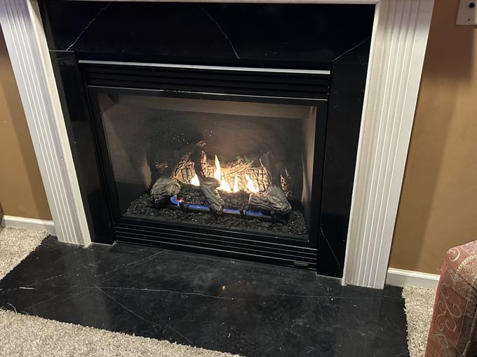 The same fireplace rebuilt and burning cleanly