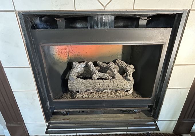 Gas fireplace with a scorched back panel before service