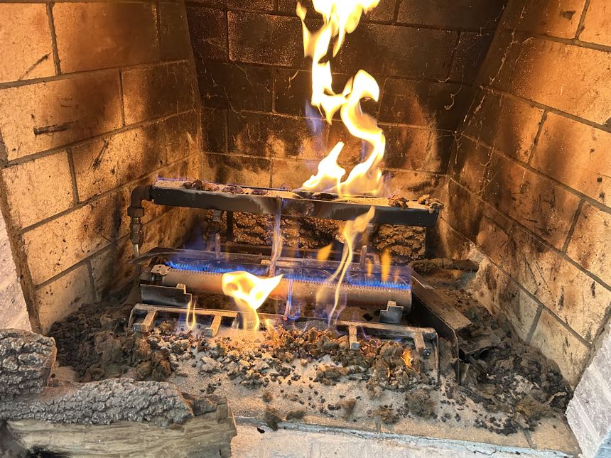 Gas logs burning with a full, even flame after service